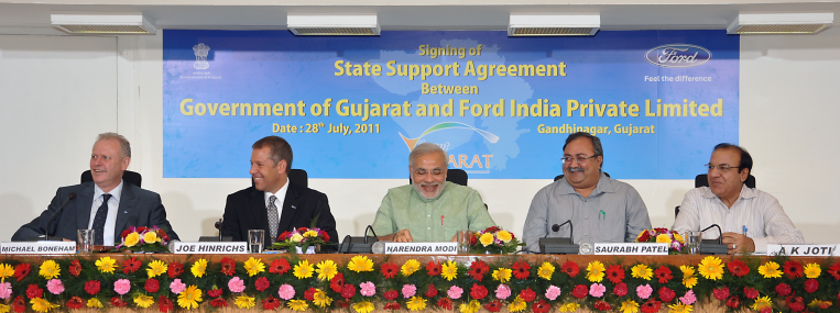 Narendra Modi, flanked by Ford executives and government officials, promoted development in Gujarat--and some say, Hindu fanaticism. (Ford Asia Pacific)