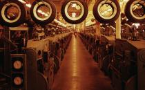 New tires travel like so many hangman’s nooses past a bank of recently installed automated curing presses at a tire factory in 1960. (Charles Rotkin / Corbis)