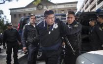 Arrests of police officers and other officials are a disconcertingly common sight in Mexico. This former federal police officer was arrested in Mexico City earlier this year and charged with leading a gang that committed robberies and kidnappings. (Getty Images)